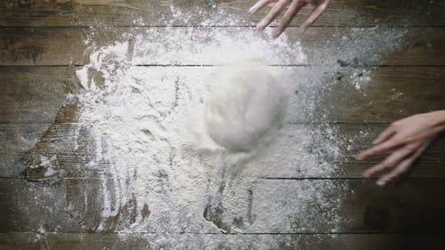 Dough Ball Placed on Floury Wooden Table