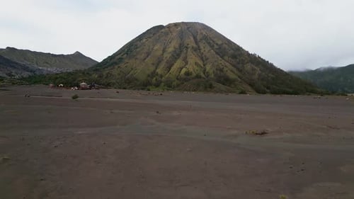 Drone Aerial View of Mount Batok Showing Steep Volcanic Slopes and Mountain Landscape East Java