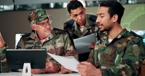 Men in Camouflage Discuss Strategy at Workplace