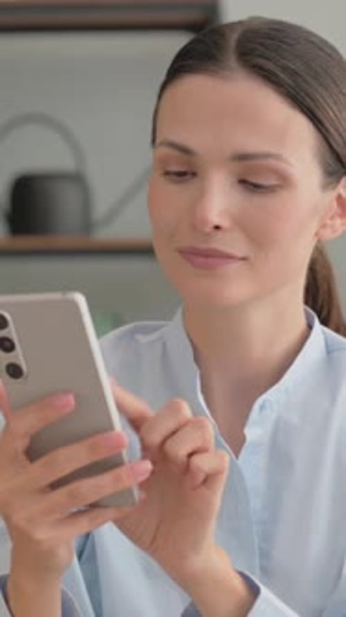 Woman Using Smartphone in Home Environment