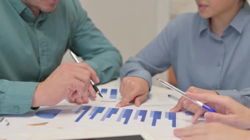 Hands of Teammates Doing Paperwork in Office