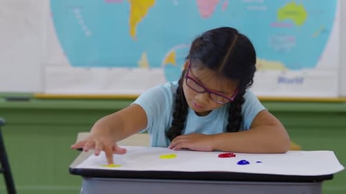 Girl Finger Painting in School Classroom Art