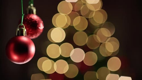 Red Christmas Ornaments with Blurred Tree Background