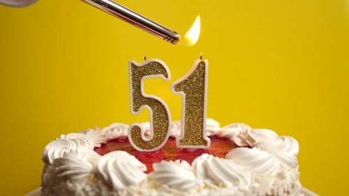 51. A candle in the form of the number 51 is lit, which is stuck into the holiday cake. Celebrating