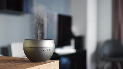 Aroma Diffuser Emitting Vapor in Modern Home