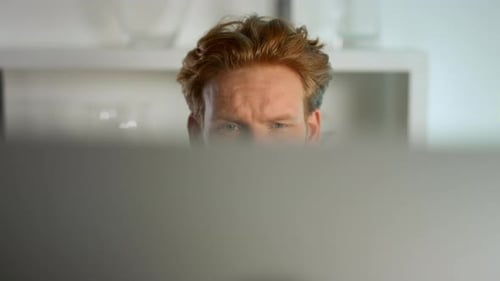 Focused Businessman Looking Computer Monitor at Home Remote Workplace Closeup. Ginger Business