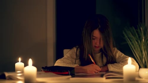 Child Studying By Candlelight At Night