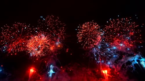 A Bunch of Fireworks Light Up the Night Sky Exploding in a Dazzling Array of Colors and Patterns