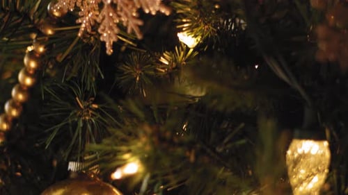 Close up of ornaments and decorations on a Christmas Tree - Slow Motion