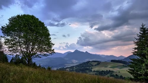 Dramatic Clouds at Dusk Rural Hilly Landscape in the Carpathians Scene with Trees and Meadow