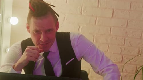 Man Video Conferencing in Office Setting