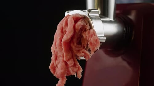 Twist a Meat or Pork Fart in a Meat Grinder Closeup Macro Mince Chicken Comes Out of the Meat