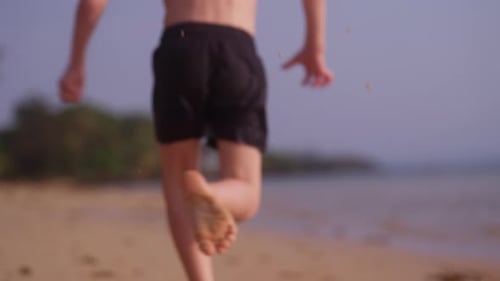 Little Boy Running On The Seashore