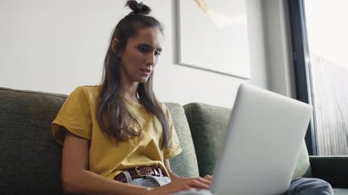 Young Woman Working on Laptop at Home