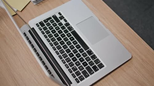 Modern Computer Standing Desk Closeup Grey Laptop at Office Wooden Workplace