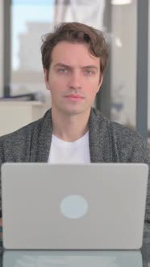 Man Working on Laptop at Desk Indoors