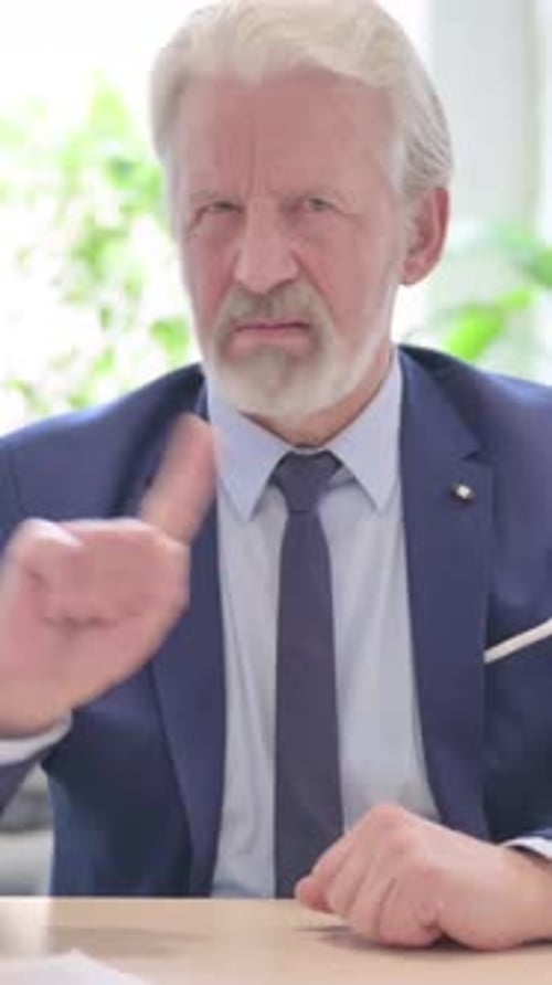 Senior Man in Suit Shaking His Head No