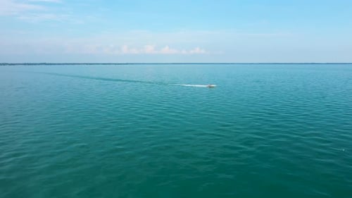 Boat Cruising on Open Water on Sunny Day