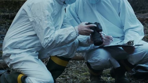 Forensic Specialist Working in the Forest Police Criminalists Collecting Evidence and Making