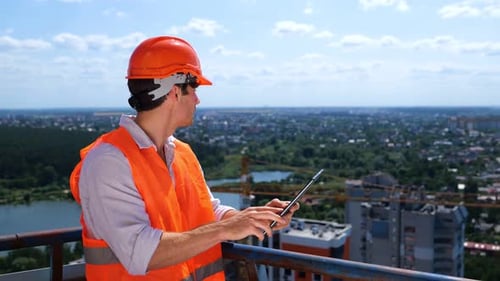 Engineer Inspects Construction Site Using Tablet