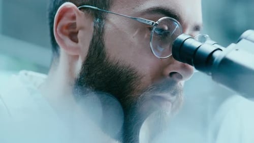 Close Up of Scientist Examining Specimen through Microscope Lens