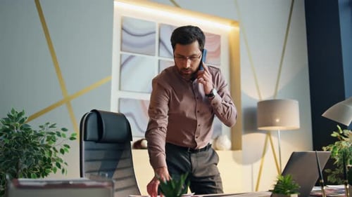 Manager Making Work Call Standing Near Office Desk. Confident Bearded Company Employee
