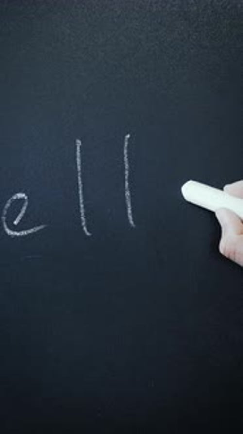 Hand Writes Hello with Chalk on Black Surface