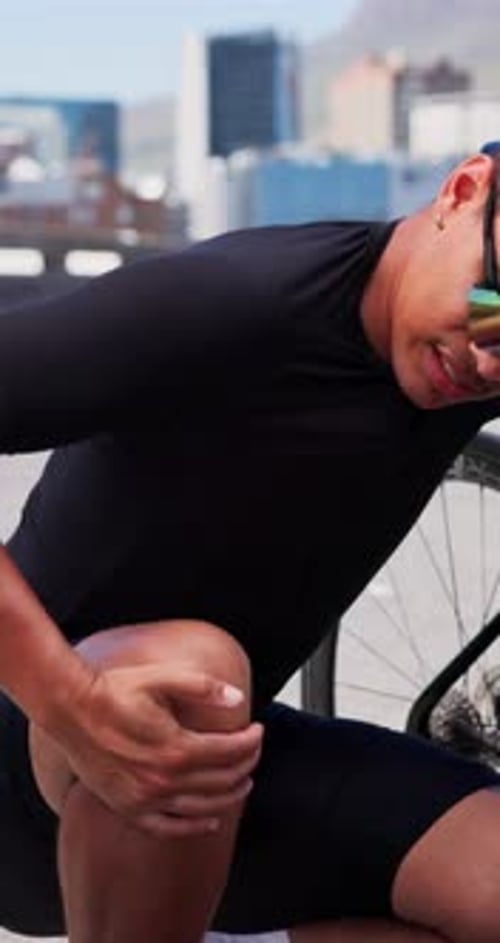 Cyclist, bicycle and man with knee pain in city for sport injury, tendon inflammation and sprain