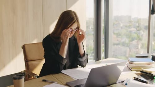 Portrait of a Beautiful Young Redhead Woman in the Office Woman Tired From a Hard Day at Work and