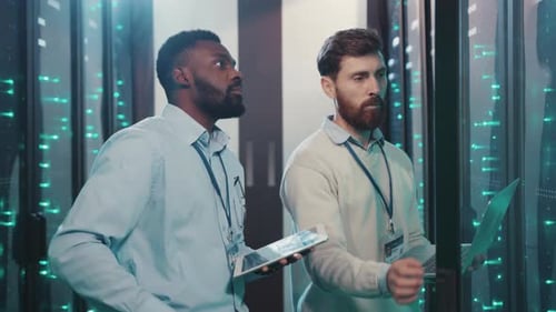 Engineers working at servers in data center