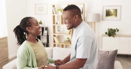 Happy Couple Holding Hands in a Bright Home