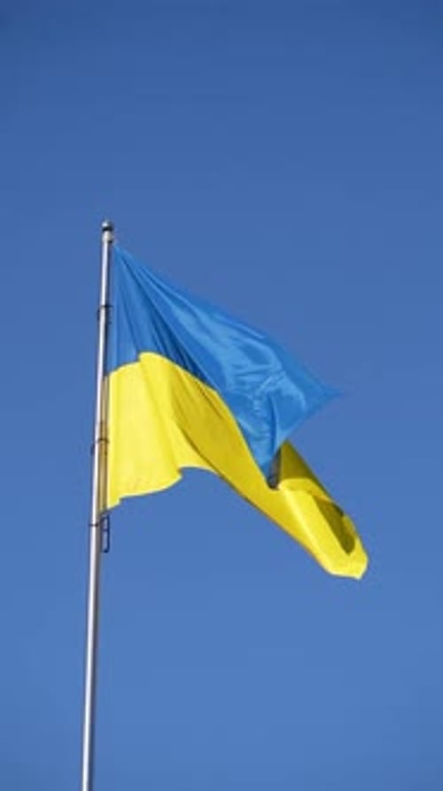 Ukrainian Flag Waving Against a Clear Blue Sky
