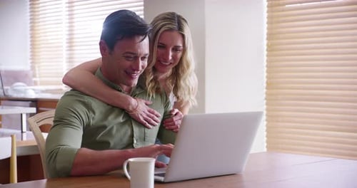 Couple Using Laptop Together at Home