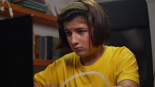 A Teenager in Front of a Computer Late at Night