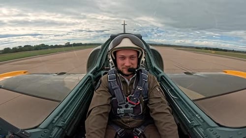 Man in Cockpit of Plane on Runway