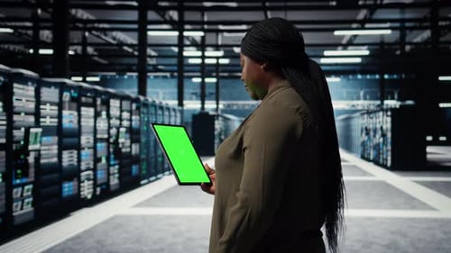 Engineer at Work Using Isolated Screen Tablet in Data Center to Check Hardware