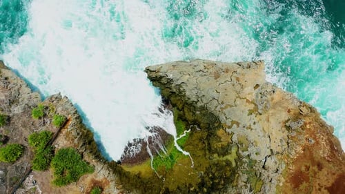 Aerial view from top of beach wave crashing in Yogyakarta, Indonesia