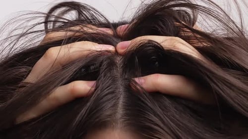 Woman Scratching Scalp with Both Hands Close Up