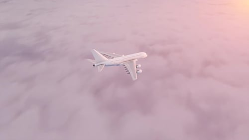 Airplane above the clouds in the rays of the morning sun