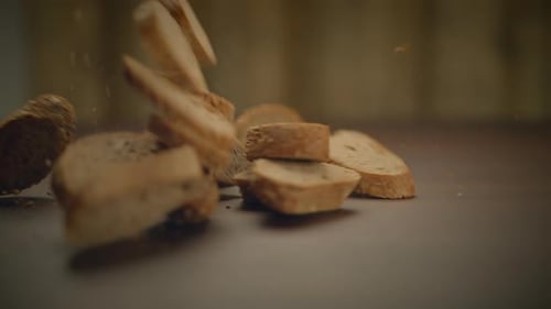 Baguette Slices Falling in Slow Motion on Table