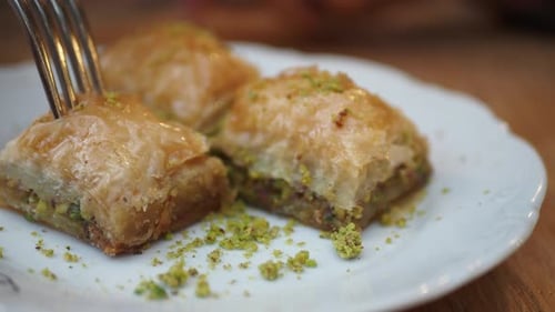 A Scrumptious and Delicious Baklava Adorned with Pistachios Elegantly Presented on a Plate