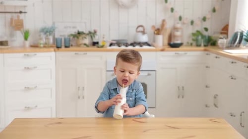 Adorable Toddler Boy Drinks Milk or Yogurt Through an Ecological Straw Concept of Conscious Care for