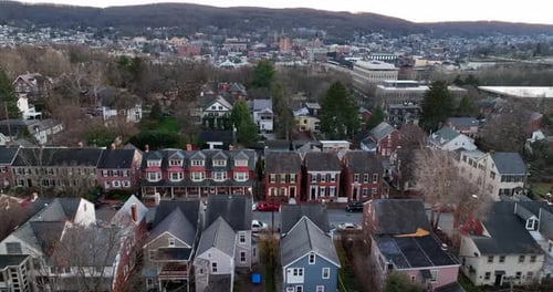Restored homes in wealthy part of town. Aerial truck shot in winter. Establishing shot. Lifestyle in