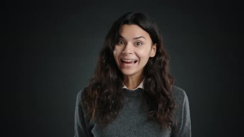 Enthusiastic Woman Gives Approval on Dark Background