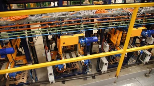 Rows of Automated Machine Tools with Cables in Workshop