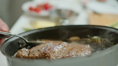 Basting Meat Steak with Batter in a Grill Pan