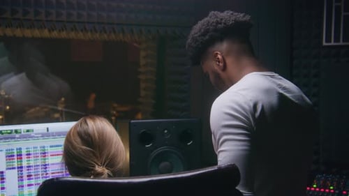 Sound Engineers Working in Recording Studio