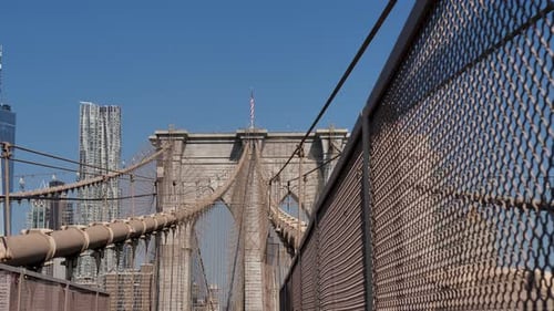Slow motion pan of landscape wires arches of Brooklyn Bridge overpass New York City CBD with Skyscra