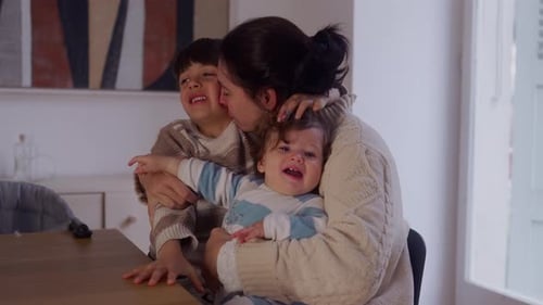 Mother Hugging Children in Home Interior Setting