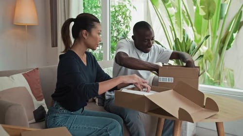 Couple Unboxing Purchases Together at Home
